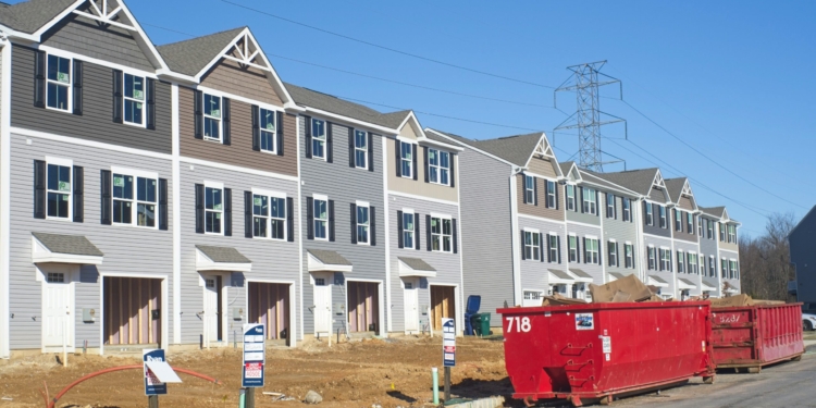 a row of houses with a red truck parked in front of them
